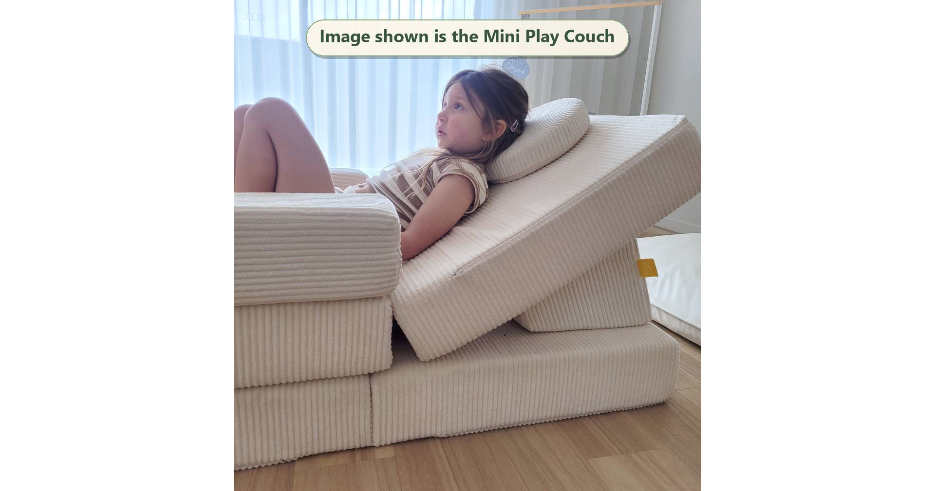 Snow white Funsquare Mini Play Couch with child lounging back on the cushioned wedge